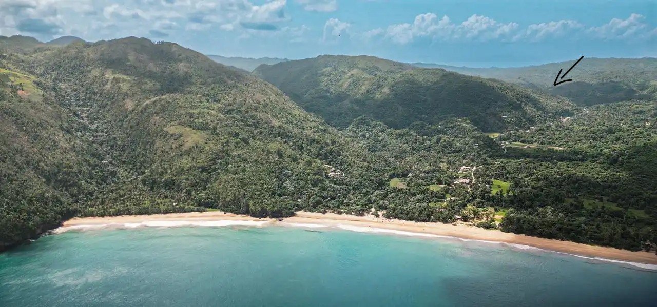 The horseshoe bay and the green valley rising behind it